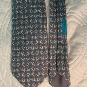 Hermés-Paris authentic 100% silk men’s necktie. Grey with Lion pattern